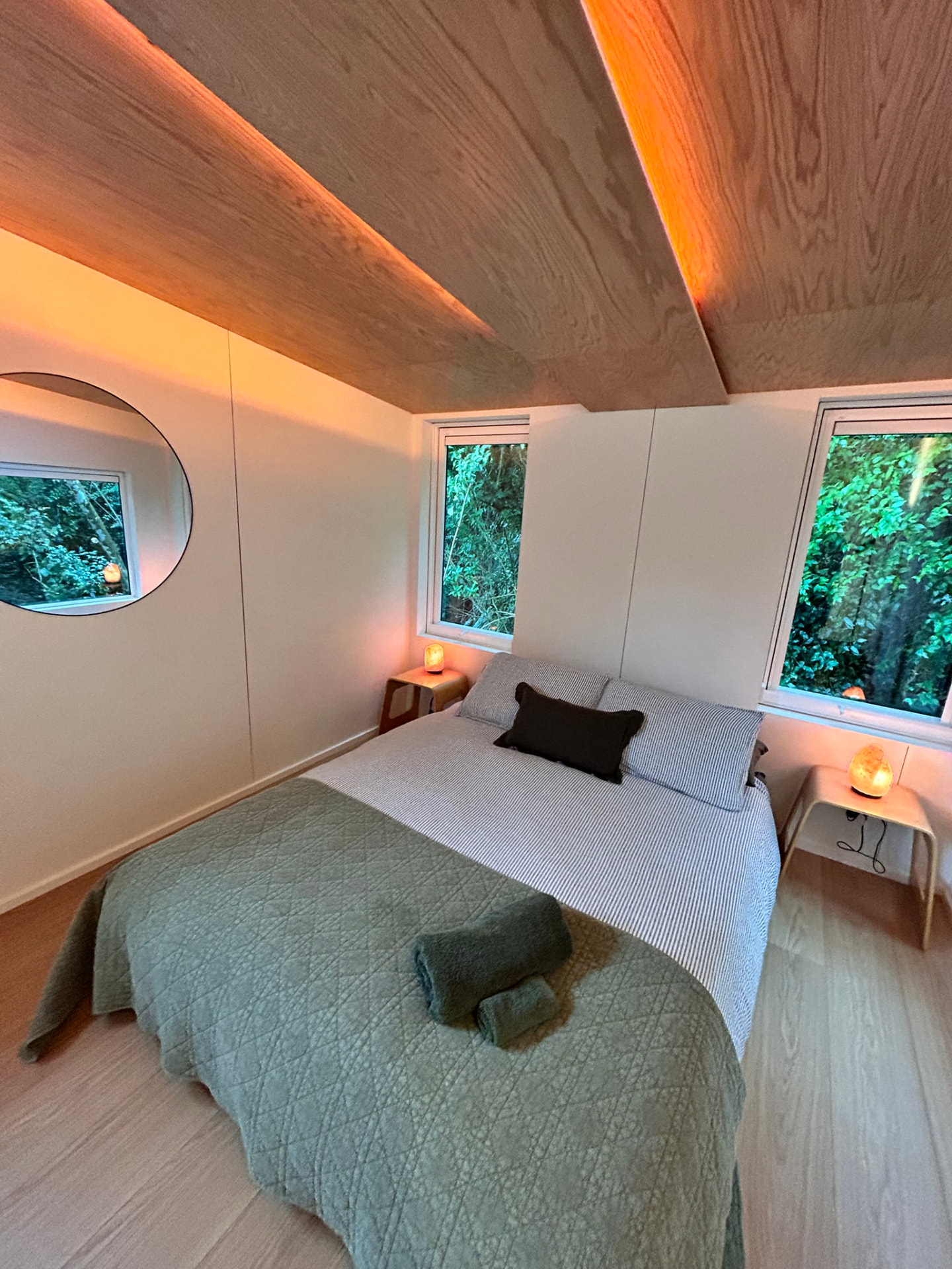 The Pod interior with bed and warm lighting