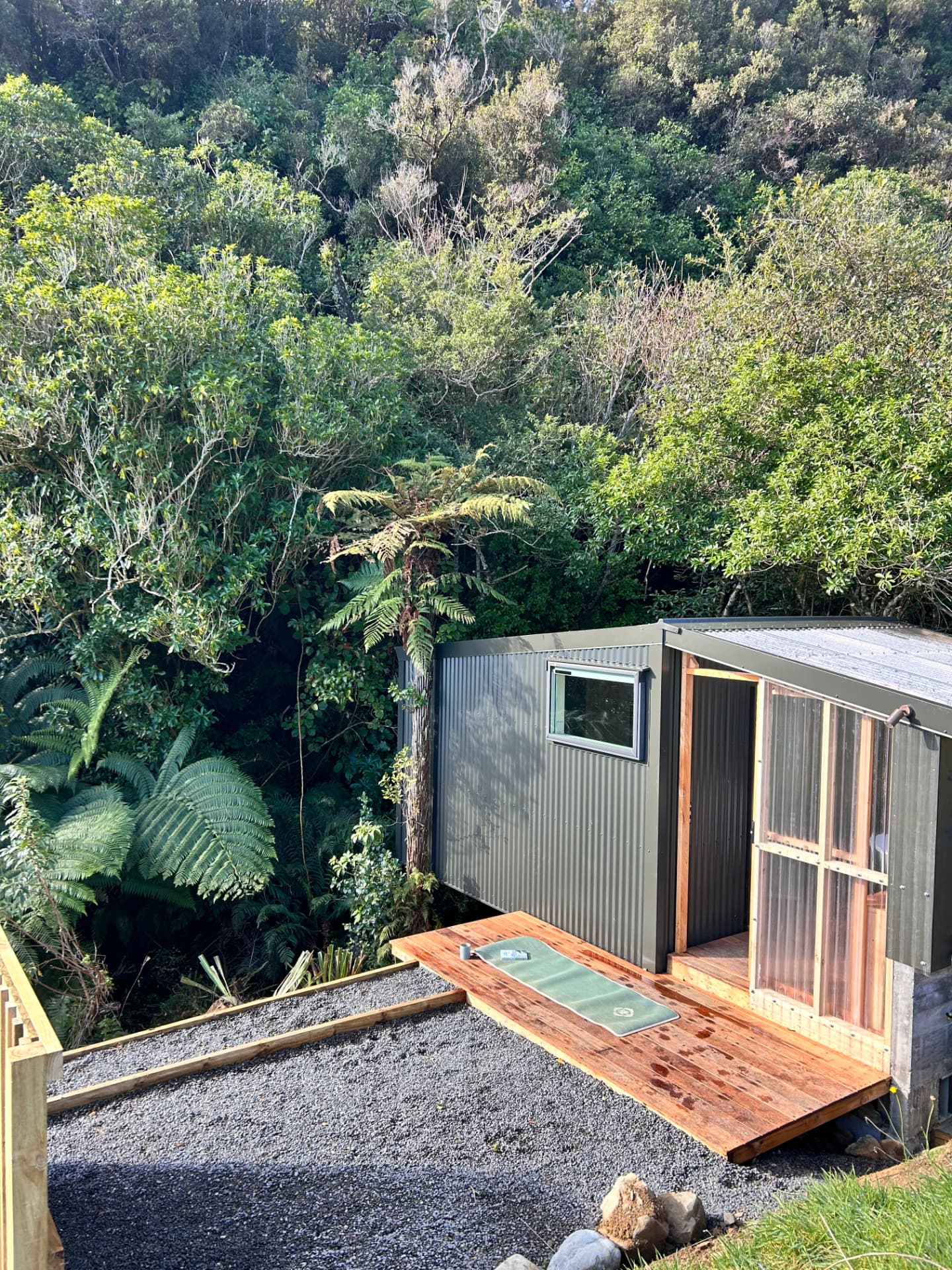 The Pod yoga deck surrounded by native bush